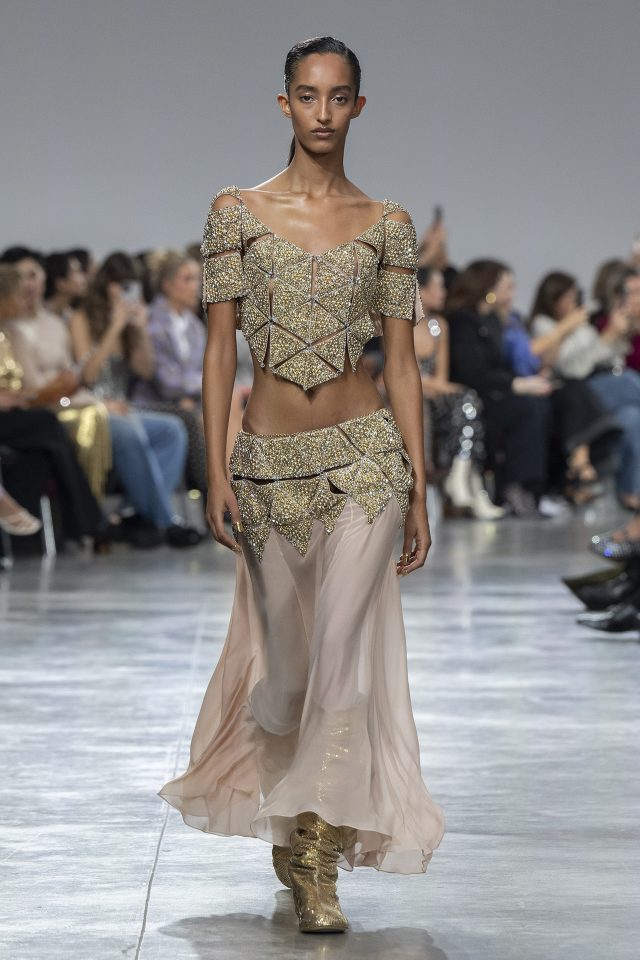 A model wearing an original creation from the womenswear spring summer 2025 ready to wear collections in Paris from the house of Rabanne